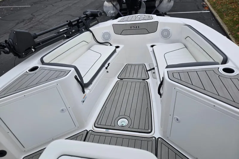 Slide: The Image of 2022 Yamaha Boats 210 FSH Sport interior with seating and storage compartments. - 16