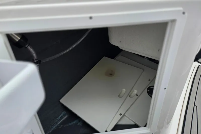 Slide: The Image of Storage compartment of 2022 Yamaha Boats 210 FSH Sport, featuring interior components. - 18