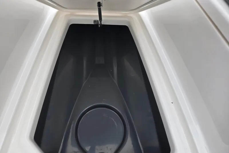 Slide: The Image of Storage compartment of 2022 Yamaha Boats 210 FSH Sport, featuring sleek interior design. - 19