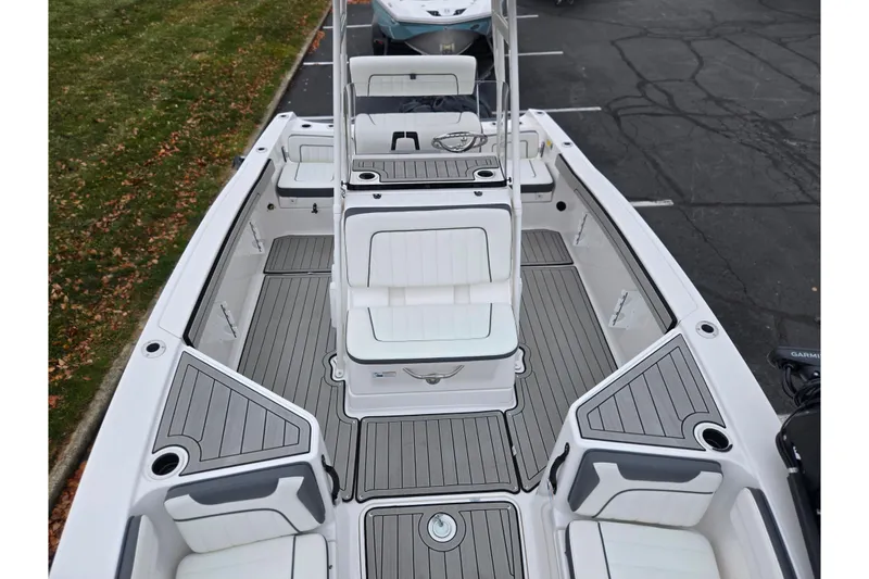 Slide: The Image of 2022 Yamaha Boats 210 FSH Sport interior with seating and storage compartments. - 23