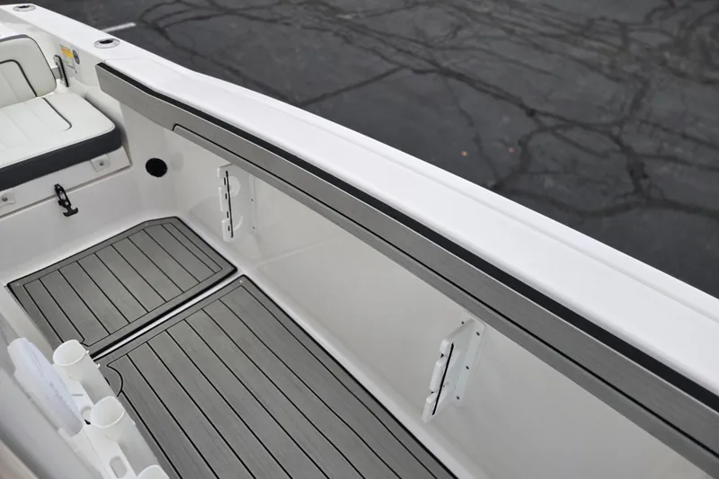 Slide: The Image of 2022 Yamaha Boats 210 FSH Sport interior with sleek seating and flooring. - 26