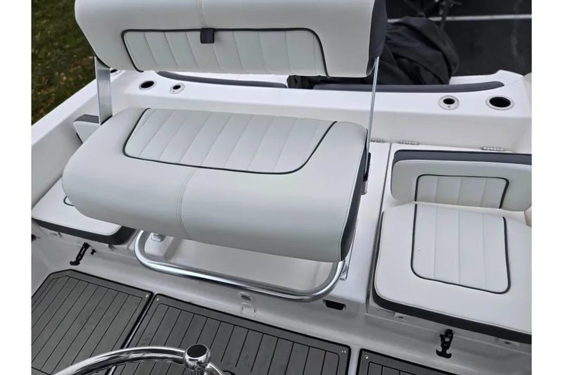 Slide: The Image of 2022 Yamaha Boats 210 FSH Sport interior seating with sleek white upholstery. - 27