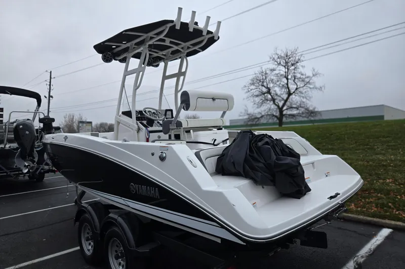 Slide: The Image of 2022 Yamaha Boats 210 FSH Sport on trailer, parked outdoors on a cloudy day. - 3