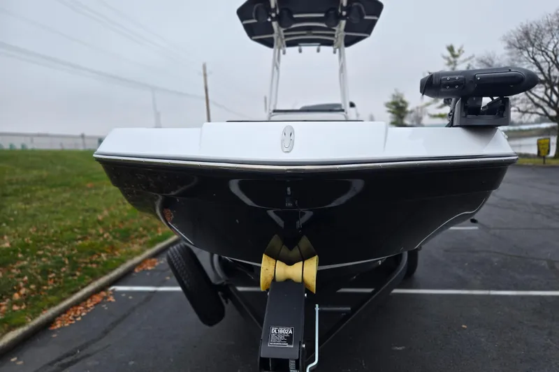Slide: The Image of 2022 Yamaha Boats 210 FSH Sport on trailer, front view in parking lot. - 7
