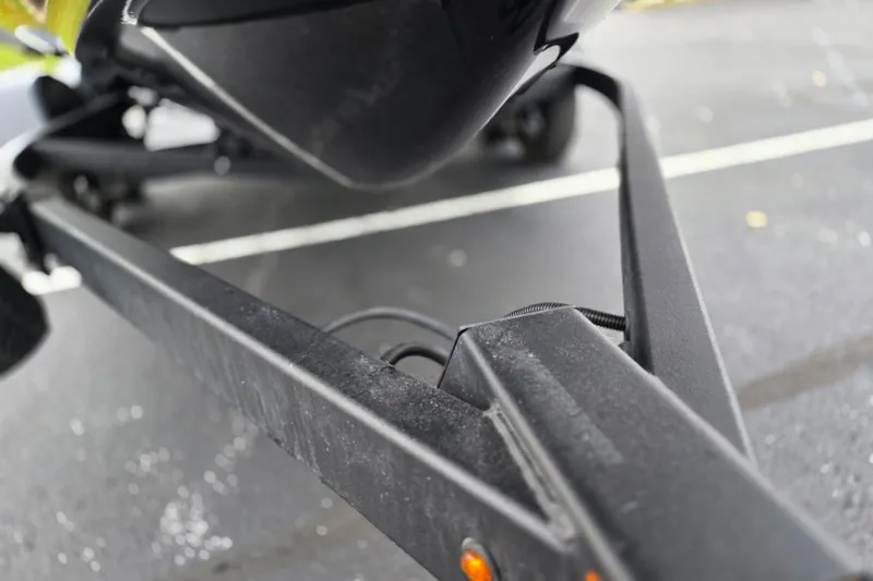 Slide: The Image of Close-up of a 2022 Yamaha Boats 210 FSH Sport trailer hitch on pavement. - 8