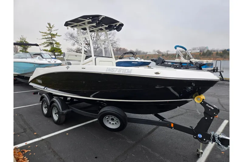 Slide: The Image of 2022 Yamaha Boats 210 FSH Sport on trailer in parking lot, overcast day. - 9