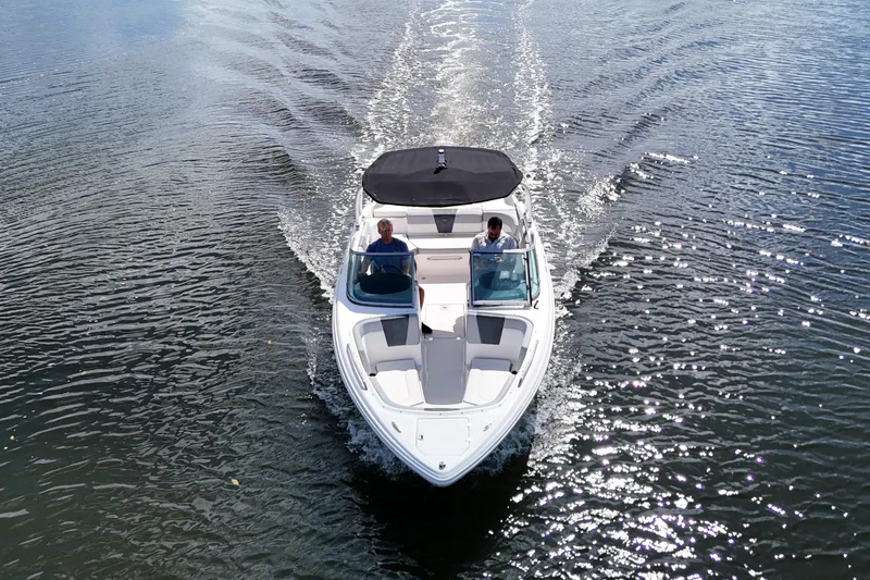 Slide: The Image of 2020 Chaparral 23 SSi boat cruising on a calm lake, top view. - 1