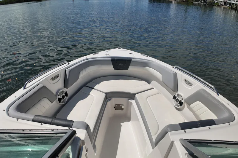 Slide: The Image of 2020 Chaparral 23 SSi boat interior with spacious seating on calm water. - 12