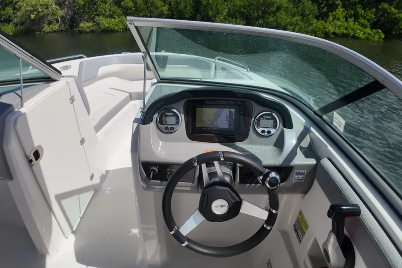 Slide: The Image of 2020 Chaparral 23 SSi boat dashboard with steering wheel and navigation display. - 20