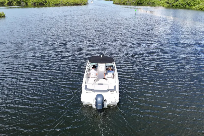 Slide: The Image of 2020 Chaparral 23 SSi boat cruising on a scenic waterway. - 4