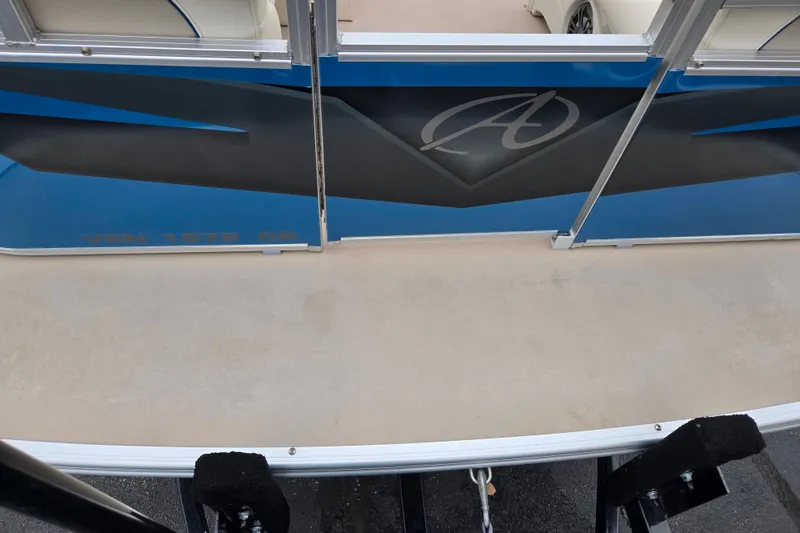 Slide: The Image of 2023 Avalon Venture CR 1575 boat deck with blue and black design. - 11
