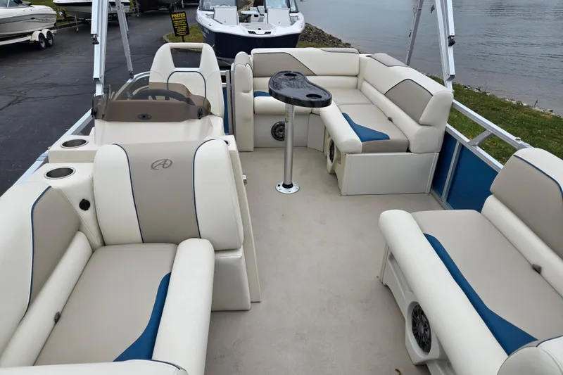 Slide: The Image of 2023 Avalon Venture CR 1575 pontoon boat interior with beige and blue seating. - 12