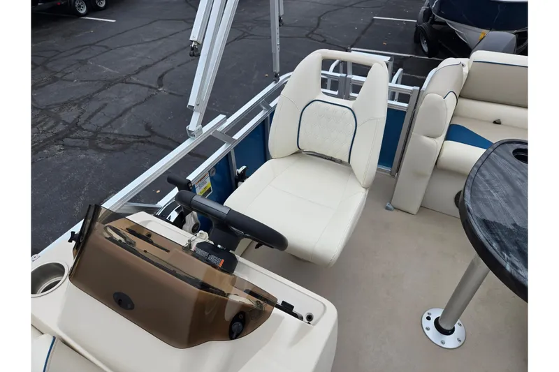 Slide: The Image of 2023 Avalon Venture CR 1575 boat interior with steering console and seating. - 13