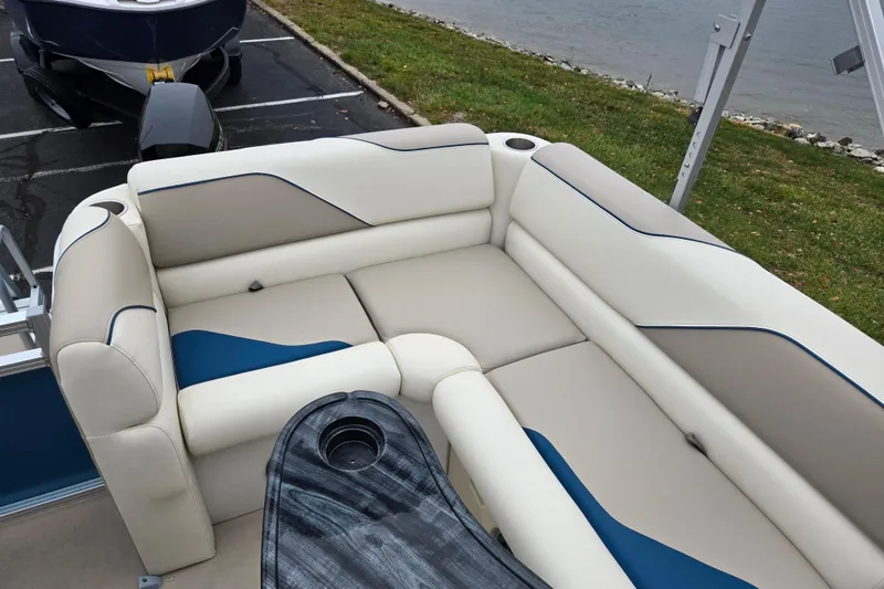 Slide: The Image of 2023 Avalon Venture CR 1575 boat interior with plush seating and cup holders. - 15