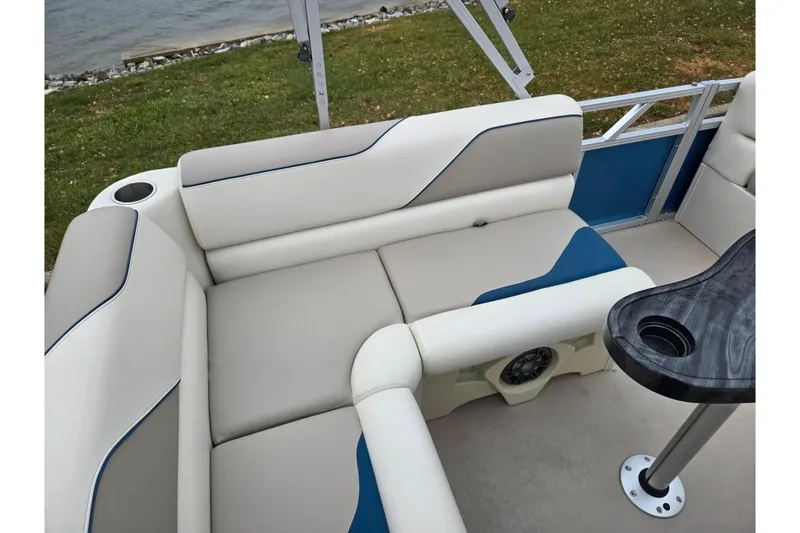 Slide: The Image of 2023 Avalon Venture CR 1575 pontoon boat interior with cushioned seating and table. - 17