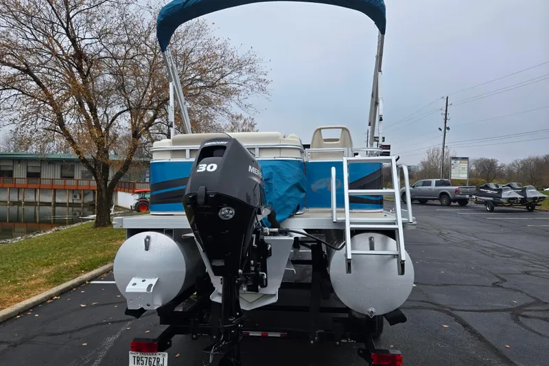 Slide: The Image of 2023 Avalon Venture CR 1575 pontoon boat with Mercury 30 engine, parked outdoors. - 2