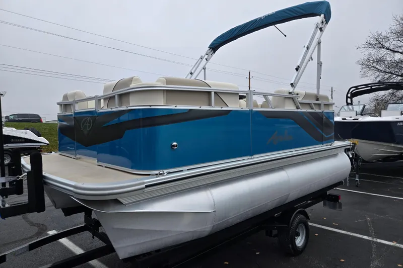 Slide: The Image of 2023 Avalon Venture CR 1575 pontoon boat with blue exterior on a trailer. - 5