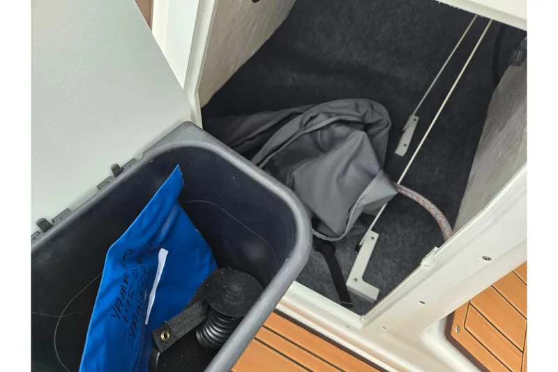 Slide: The Image of Storage compartment of 2023 Yamaha Boats 195S with equipment and accessories. - 15