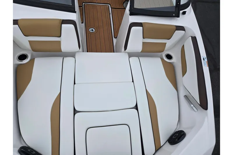 Slide: The Image of 2023 Yamaha Boats 195S interior with tan and white seating, featuring sleek design and wood accents. - 17