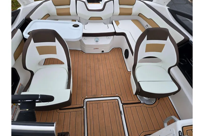 Slide: The Image of 2023 Yamaha Boats 195S interior with stylish seating and wood-patterned flooring. - 19