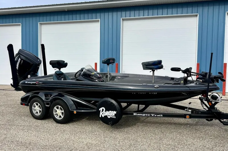 Slide: The Image of 2017 Ranger Z519 boat on trailer, parked outside blue building. - 13
