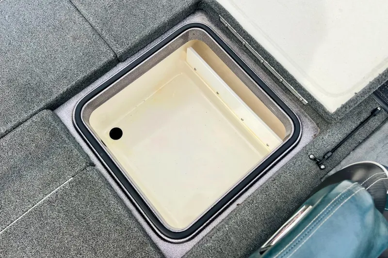 Slide: The Image of 2017 Ranger Z519 boat storage compartment with gray carpet interior. - 15
