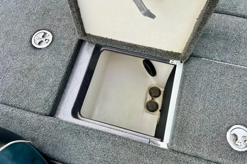 Slide: The Image of 2017 Ranger Z519 boat storage compartment with open lid, showing interior details. - 19