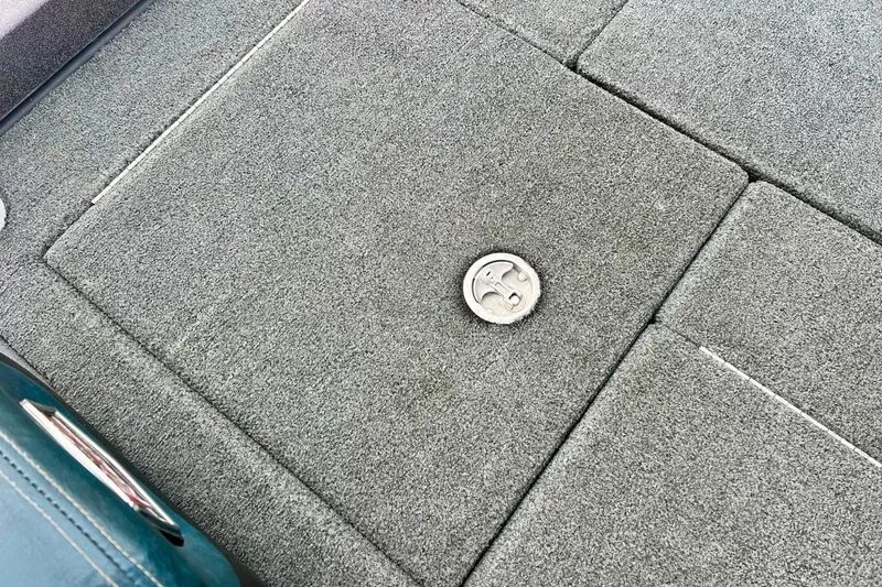 Slide: The Image of 2017 Ranger Z519 boat deck with gray carpet and metal latch. - 20