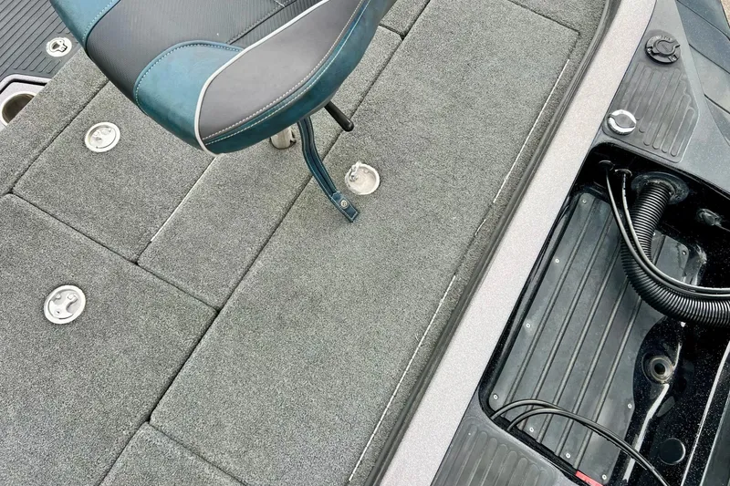 Slide: The Image of 2017 Ranger Z519 boat interior with gray carpet and seating. - 22