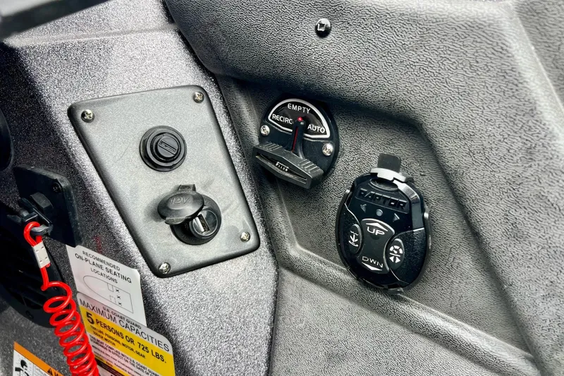 Slide: The Image of Control panel of a 2017 Ranger Z519 boat with switches and dials. - 33