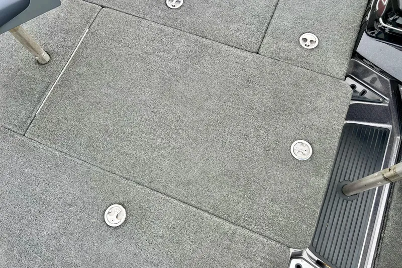 Slide: The Image of 2017 Ranger Z519 boat deck with gray carpet and metal fixtures. - 46