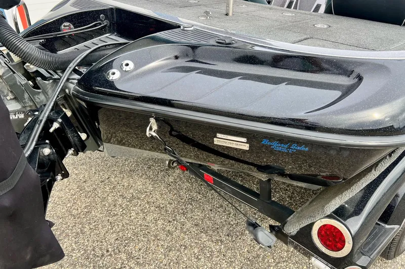 Slide: The Image of 2017 Ranger Z519 boat rear view, featuring sleek black design and trailer attachment. - 5