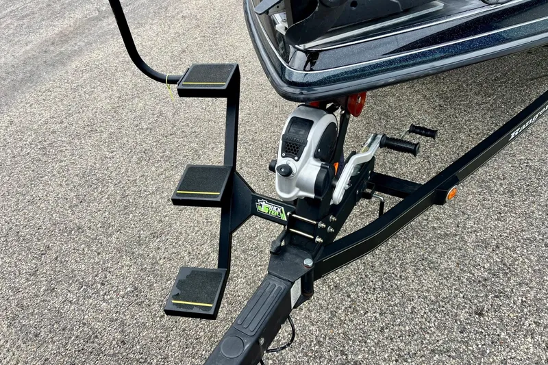Slide: The Image of 2017 Ranger Z519 boat trailer with steps and winch on asphalt surface. - 55