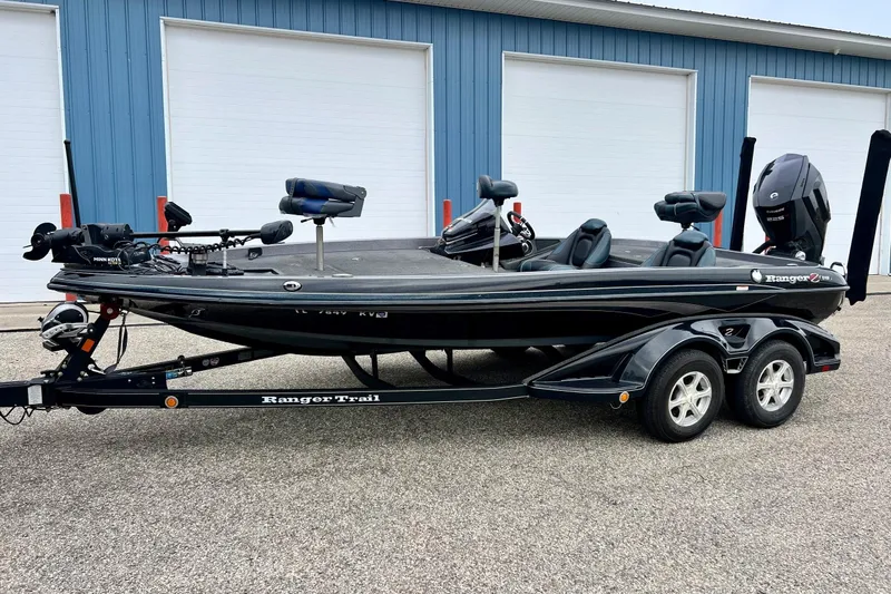Slide: The Image of 2017 Ranger Z519 fishing boat on trailer, parked outside blue building. - 56