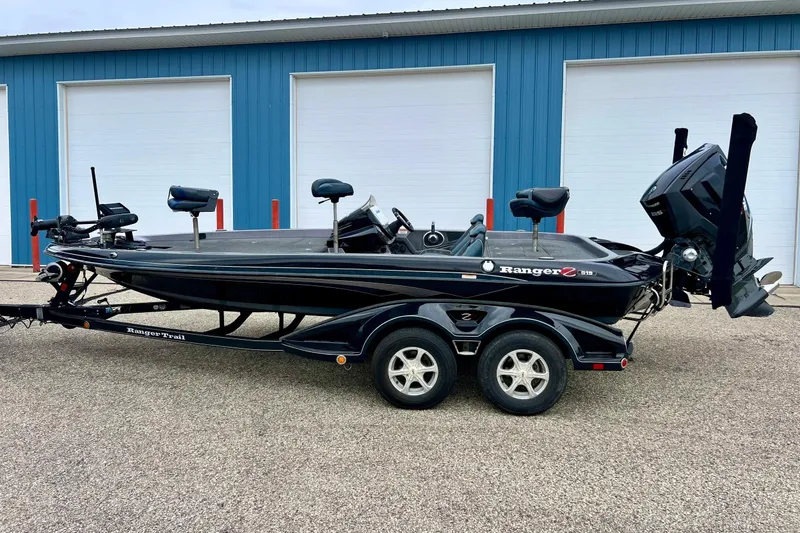 Slide: The Image of 2017 Ranger Z519 bass boat on trailer, parked outside blue building. - 57