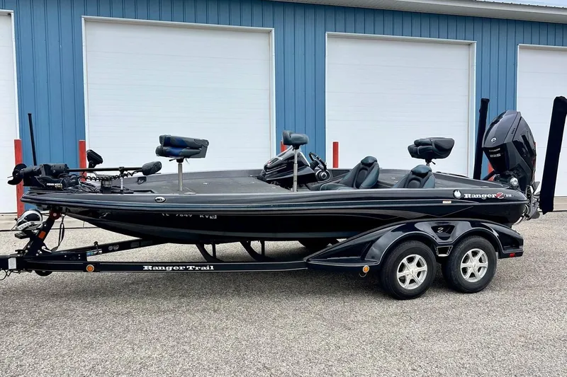 Slide: The Image of 2017 Ranger Z519 bass boat on trailer, parked outside blue building. - 58