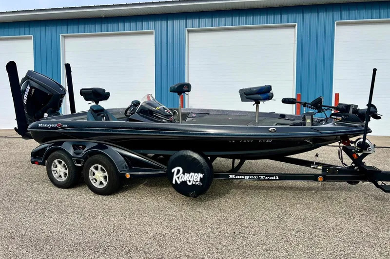 Slide: The Image of 2017 Ranger Z519 boat on trailer, parked in front of blue building. - 6