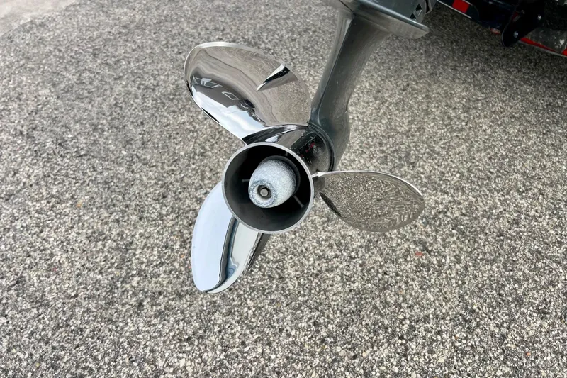Slide: The Image of Close-up of a 2017 Ranger Z519 boat propeller on asphalt surface. - 9