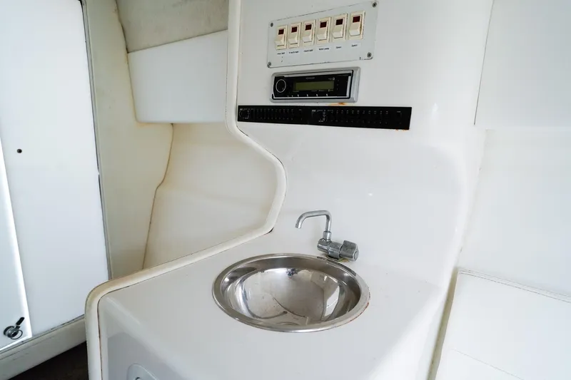 Slide: The Image of Interior cabin of a 2000 Active Thunder 32 boat, featuring white seating and speakers. - 14