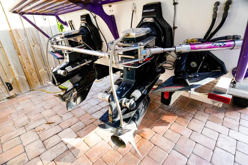 Slide: The Image of Twin Mercury outboard engines on a 2000 Active Thunder 32 boat, displayed on a brick surface. - 22