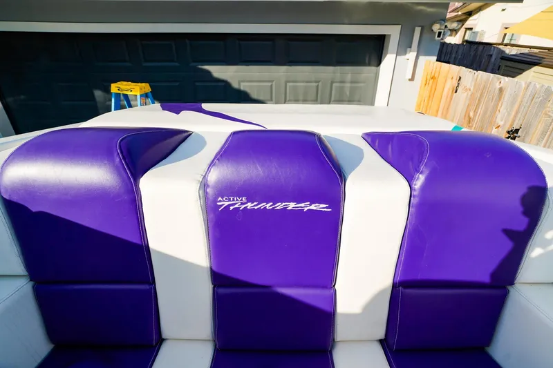 Slide: The Image of Purple and white seating in a 2000 Active Thunder 32 boat interior. - 6