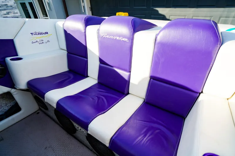 Slide: The Image of Cockpit of a 2000 Active Thunder 32 boat with purple and white seating. - 7
