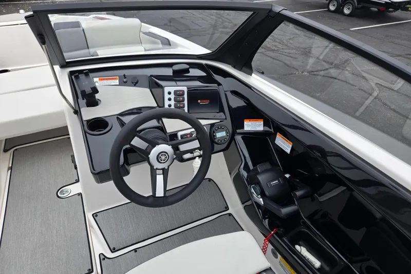 Slide: The Image of 2025 Yamaha Boats AR220 cockpit with steering wheel and control panel. - 12