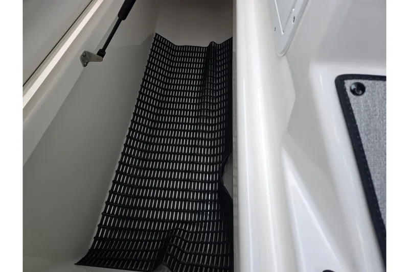 Slide: The Image of 2025 Yamaha Boats AR220 interior storage compartment with black mat. - 18