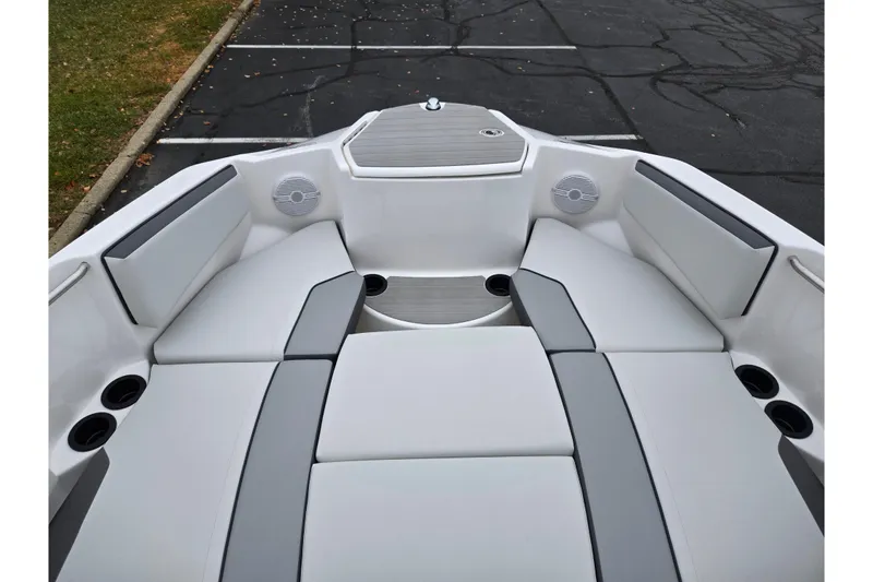 Slide: The Image of 2025 Yamaha Boats AR220 interior with cushioned seating and cup holders. - 19