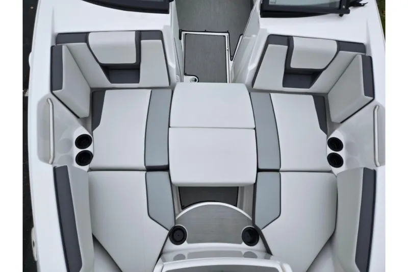 Slide: The Image of 2025 Yamaha Boats AR220 interior seating with modern design and cup holders. - 21