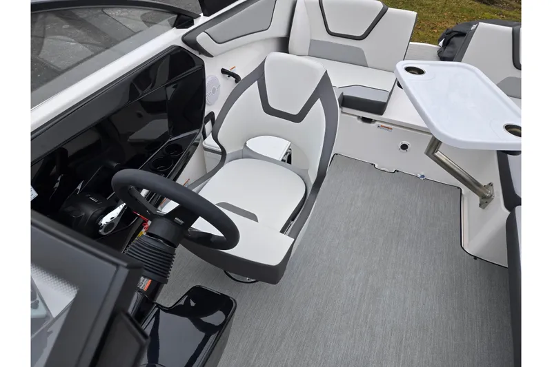 Slide: The Image of 2025 Yamaha Boats AR220 interior with modern seating and steering wheel. - 23