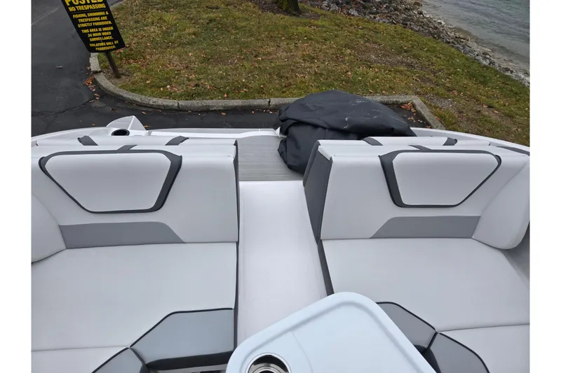 Slide: The Image of 2025 Yamaha Boats AR220 interior with sleek seating and modern design by the water. - 25