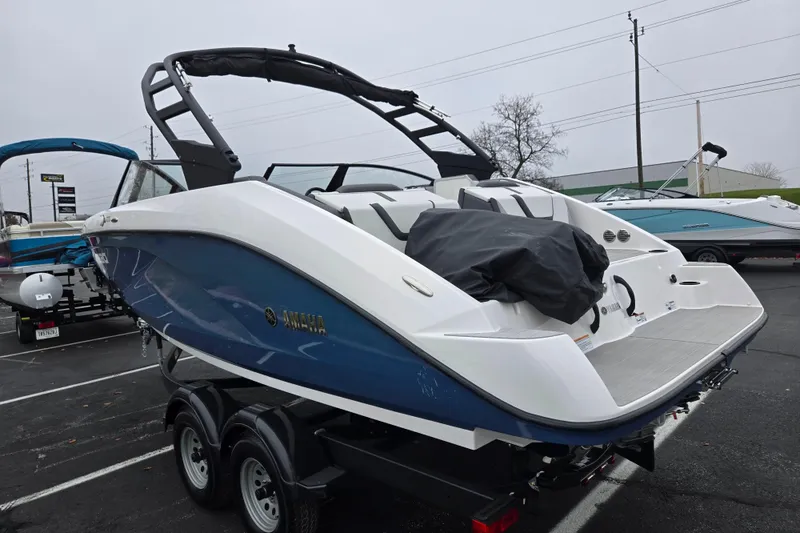 Slide: The Image of 2025 Yamaha Boats AR220 in a parking lot, showcasing sleek design and modern features. - 3
