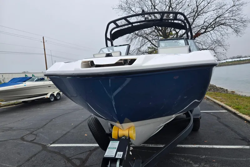 Slide: The Image of 2025 Yamaha Boats AR220 on trailer, parked near waterfront. - 6